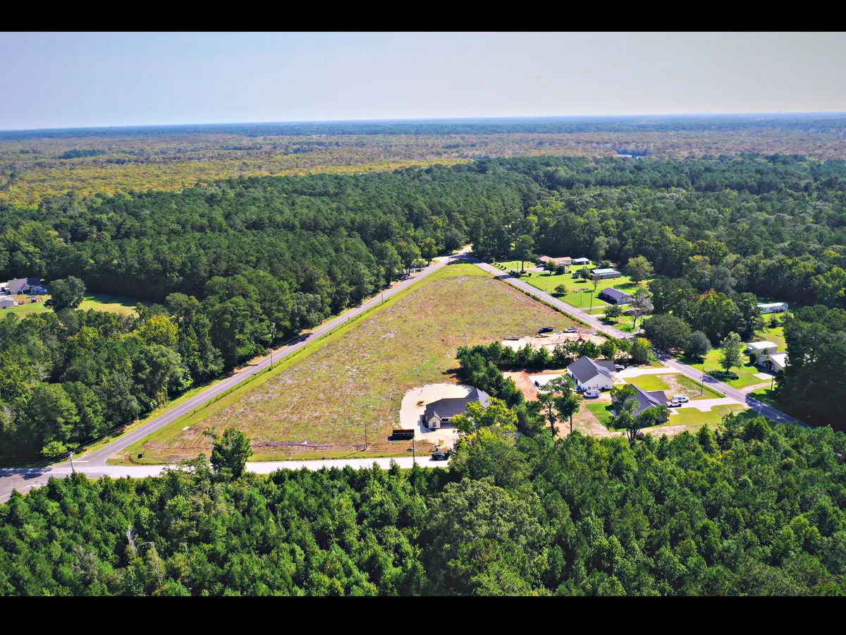 Aerial view of the cleared Bucksville Crossing parcel, bordered by roads and pine woods